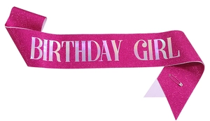 Detail of glitter pink Birthday Girl sash with silver holographic lettering and pin