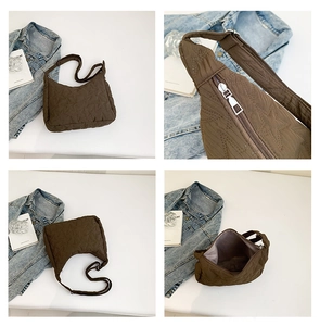 Detail view of brown star quilted hobo bag with adjustable strap and metal zipper