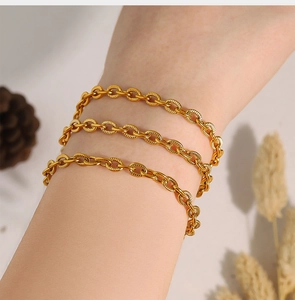Close-up of 18K gold-plated stainless steel chunky chain bracelet worn on a wrist