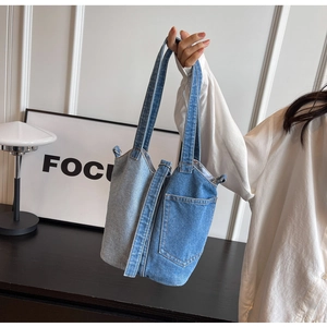 Detailed close-up of patchwork denim bucket bag with side pocket and sturdy handles