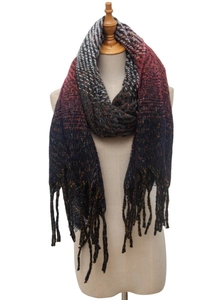 Close-up of knit shawl texture with ombre gradient color and fringe tassel details