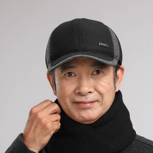 Close-up of men's winter baseball cap with ear flaps and thick matching knit scarf set
