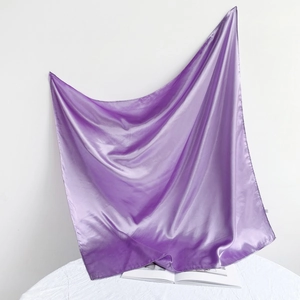 Close-up of elegant purple satin square scarf with a smooth silk finish and glossy texture