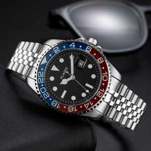Detail of red and blue bezel luxury stainless steel watch on premium leather surface