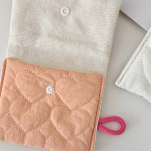 Close-up of quilted heart pattern on cotton canvas storage bag with snap button closure