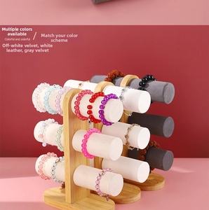 Detailed view of the 3-tier bamboo jewelry stand with grey velvet and white leather bars