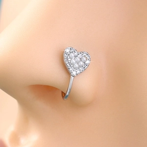 Close-up of a heart-shaped nose ring with small pearls and crystals on a model
