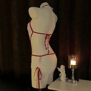 White halter backless nurse lingerie set with red trim and drawstring mini skirt on mannequin