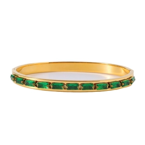 Detail of 18k gold plated bangle featuring rectangle emerald green gemstones