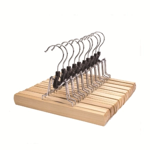 Detail view of solid wood skirt clips with black non-slip pads and stainless steel hooks