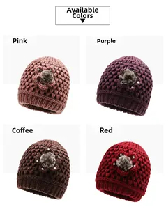 Close-up of knit winter hats with floral rhinestone decor in pink purple coffee and red