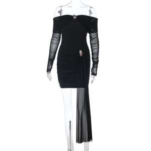 Close-up of off-shoulder black mesh dress with ruched texture and metal buckle accents