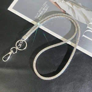 Luxury rhinestone phone lanyard with silver lobster clasp on a black leather background