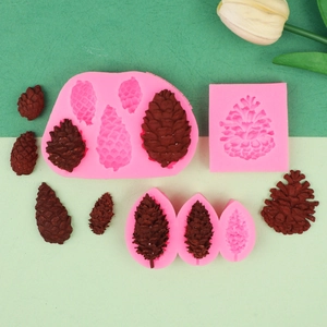 Detailed pink silicone pinecone molds shown with realistic chocolate pinecone shapes