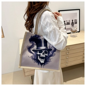 Lifestyle view of large canvas tote bag featuring stylized skull print and linen texture