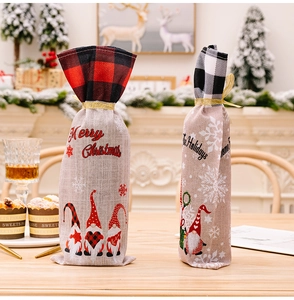 Detail of buffalo plaid Christmas wine bottle bags with drawstrings on a festive table