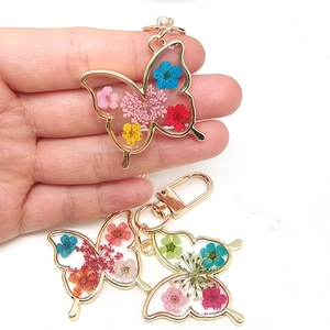 Handmade butterfly resin keychain with colorful real dried flowers and gold metal frame