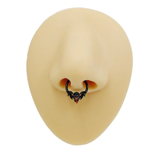 Gothic black bat and skull septum ring with red accents on a realistic nose model