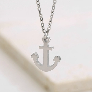 Macro shot of silver anchor pendant necklace showing polished stainless steel texture