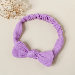 Detailed view of purple cotton bow headband with soft elastic pleated texture for babies