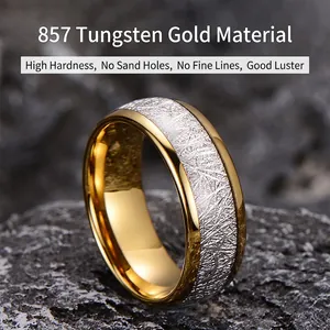 Polished two-tone tungsten steel ring with silver textured inlay on a dark rock surface