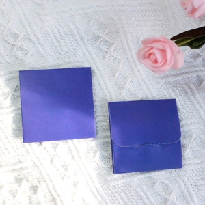 Purple jewelry polishing cloth for cleaning silver and gold rings on white textured background