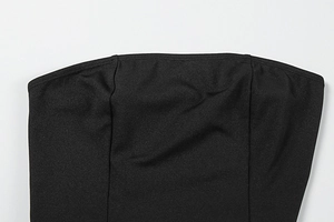 Close-up of the double-stitched neckline on a black off-the-shoulder party dress