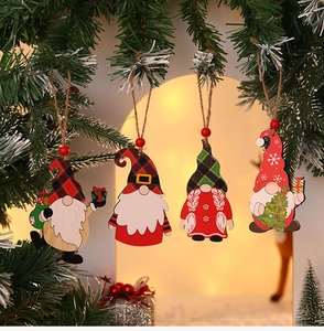 Detailed view of four wooden Christmas gnome ornaments with festive plaid hats and jute strings