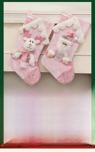 Detailed close-up of pink sequined Christmas stockings with 3D Santa and reindeer figures