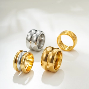 Minimalist 18K gold and silver wide band rings in layered and textured designs