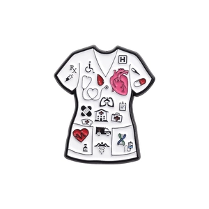 Close-up of white enamel medical scrub brooch with icons like stethoscope and heart