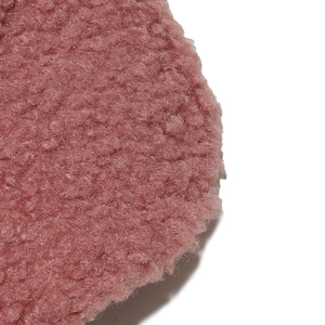 Close-up of pink sherpa fleece texture on a baseball cap with soft embroidered fabric details