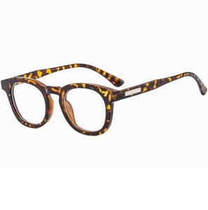 Detail view of retro round tortoiseshell eyeglass frames with clear lenses from a 45-degree angle