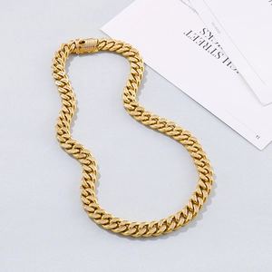 Macro shot of gold cuban link necklace with shimmering diamonds and square clasp