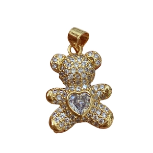 Golden heart bear pendant necklace with sparkling clear cubic zirconia on white background