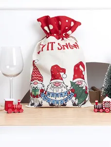 Detail of Christmas gnome drawstring candy bag made of burlap with festive patterns