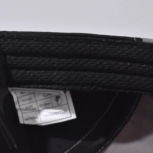 Detail of the high-quality 100% cotton baseball cap showing inner stitching and size tag