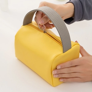 Wasserdichte gelbe PU-Kosmetiktasche mit grauem Griff und goldenem Reißverschluss