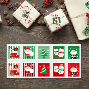 Detail showing vintage Christmas stamp stickers with Santa and tree motifs on wooden table
