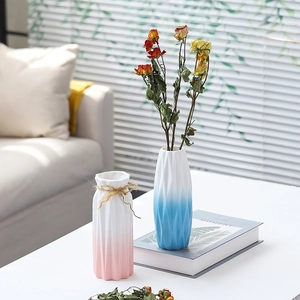 Close-up of modern gradient ceramic vases with diamond texture and decorative hemp rope
