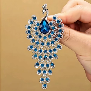 Elegant peacock brooch with blue teardrop crystals and silver metal for women's suits