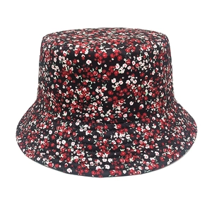 Close-up of floral print bucket hat with red and pink blossoms on dark fabric