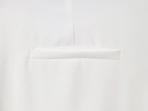 Close-up showing the precise stitching and welt pocket detail on white blazer jacket