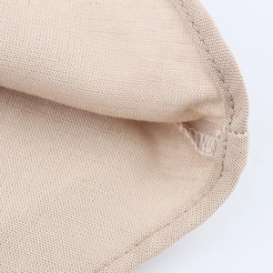 Macro shot of beige fabric texture and precision stitching on the midi dress seam