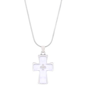 Detail showing silver cross pendant with white inlay on a thin snake chain necklace