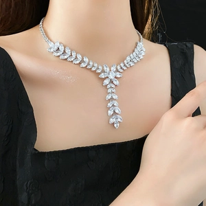 Detailed view of silver-tone wheat-ear tassel necklace with sparkling zircon crystals
