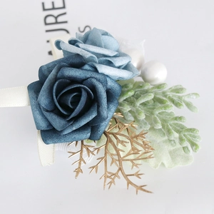 Elegant blue artificial rose boutonniere with gold leaves and white pearls for weddings