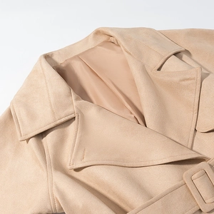 Close-up of lapel collar and faux suede fabric texture on light tan cropped jacket