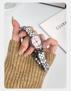 Close-up of Gedi ladies watch featuring pink dial and silver honeycomb bracelet.