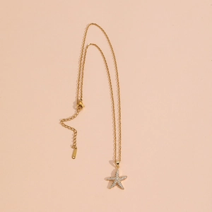 Elegant gold starfish pendant necklace with white zircon insets on stainless steel chain